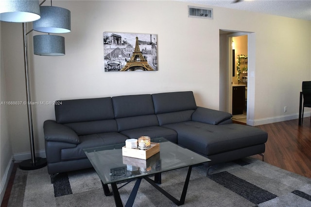 living room with dark hardwood / wood-style flooring and a textured ceiling