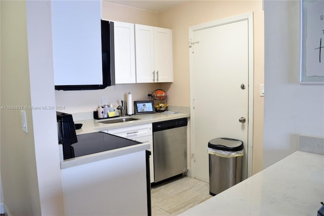 kitchen with dishwasher, white cabinets, and sink