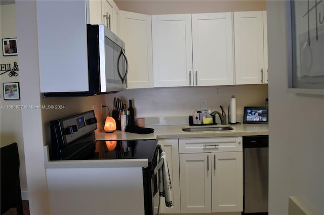 kitchen featuring stainless steel appliances, white cabinets, and sink