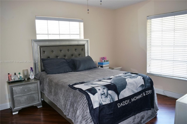 bedroom with dark hardwood / wood-style flooring