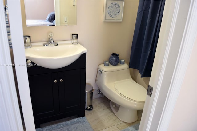 bathroom featuring tile patterned flooring, vanity, and toilet