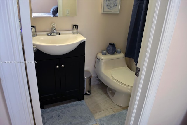 bathroom featuring toilet and vanity