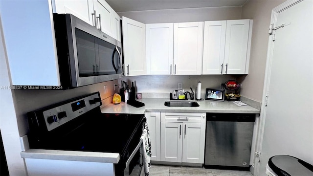 kitchen with white cabinetry, appliances with stainless steel finishes, and sink