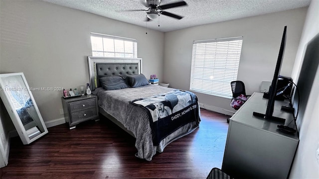 bedroom with ceiling fan, dark hardwood / wood-style floors, and a textured ceiling