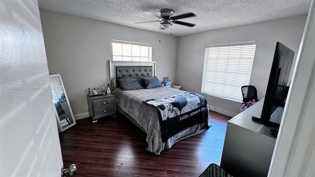 bedroom with dark hardwood / wood-style flooring, a textured ceiling, and ceiling fan