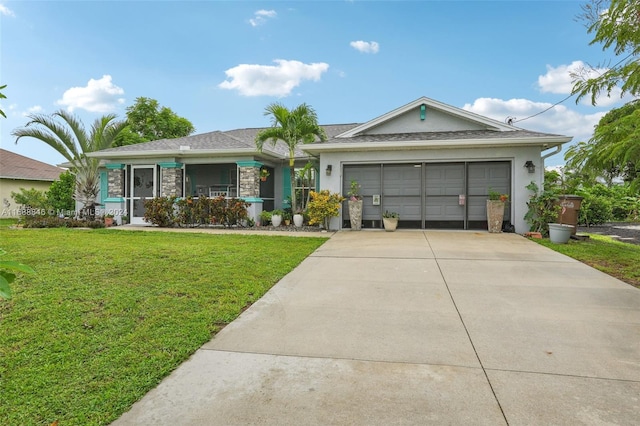 ranch-style home featuring covered porch, a garage, and a front yard