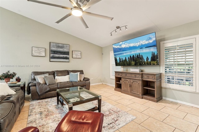 living room featuring ceiling fan, light tile patterned floors, and vaulted ceiling