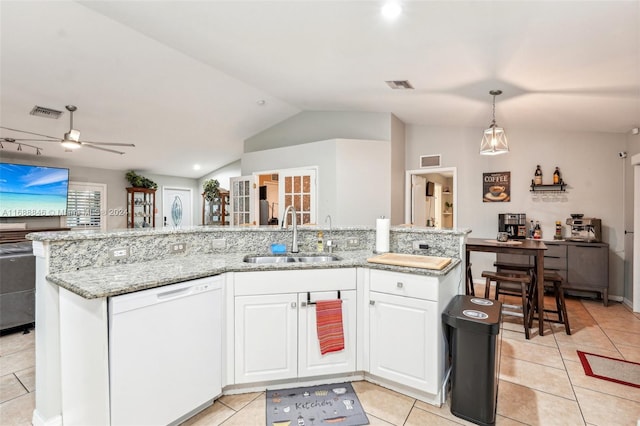 kitchen featuring white dishwasher, vaulted ceiling, sink, a kitchen island with sink, and white cabinetry