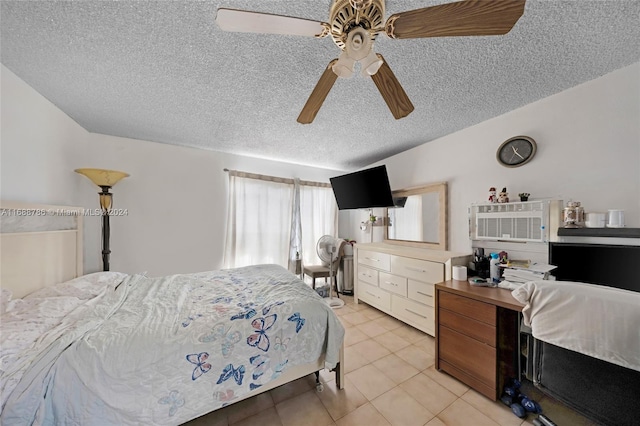 bedroom with a textured ceiling, ceiling fan, and light tile patterned flooring