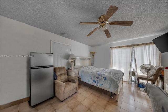 bedroom featuring a textured ceiling, ceiling fan, and stainless steel fridge