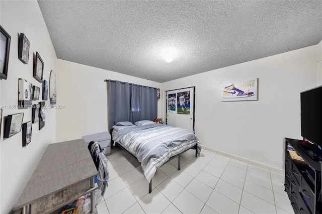 tiled bedroom with a textured ceiling