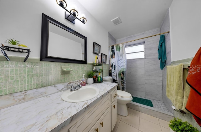 bathroom featuring tile walls, a shower with curtain, vanity, tile patterned flooring, and toilet