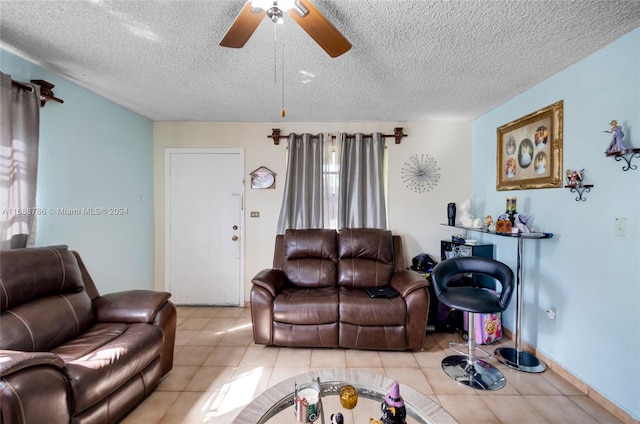 tiled living room with a textured ceiling and ceiling fan