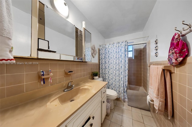 bathroom with tile walls, vanity, tile patterned flooring, curtained shower, and toilet