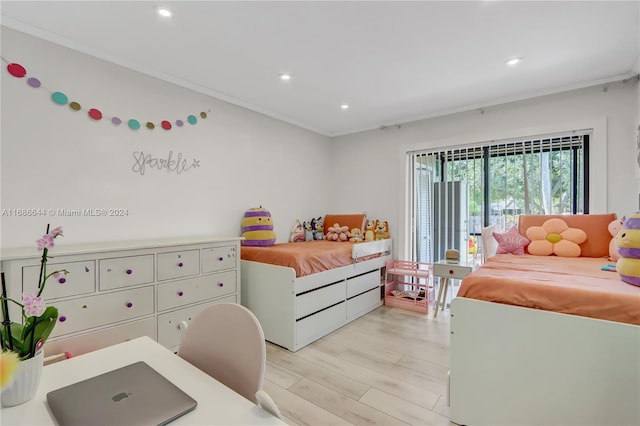 bedroom featuring light hardwood / wood-style floors and crown molding