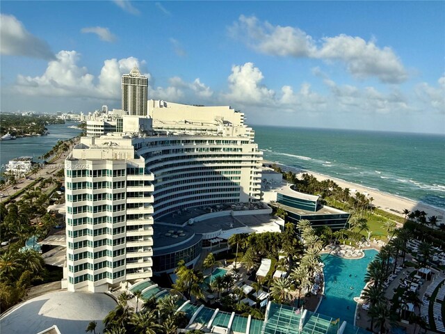 drone / aerial view featuring a beach view and a water view