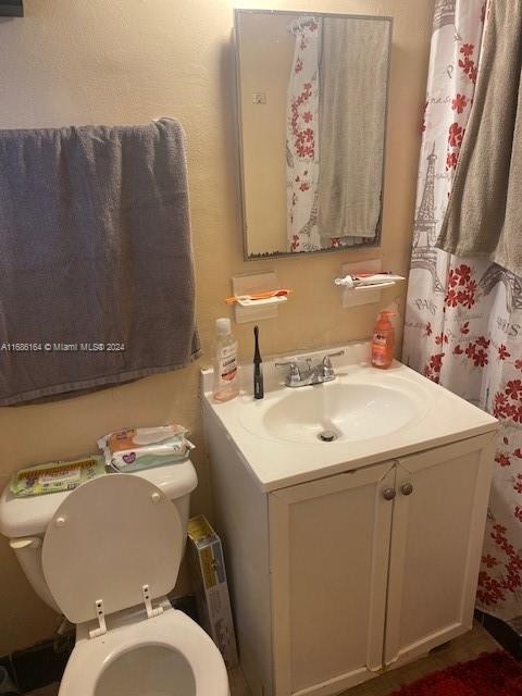 bathroom featuring toilet and vanity