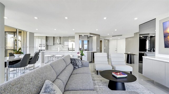 kitchen with gray cabinetry, light stone countertops, appliances with stainless steel finishes, and sink