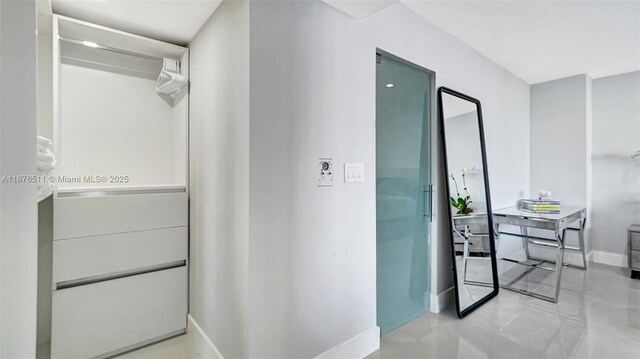 bathroom with toilet, vanity, tile patterned floors, and a shower with door