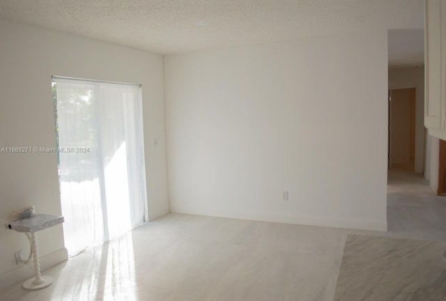 spare room with a textured ceiling