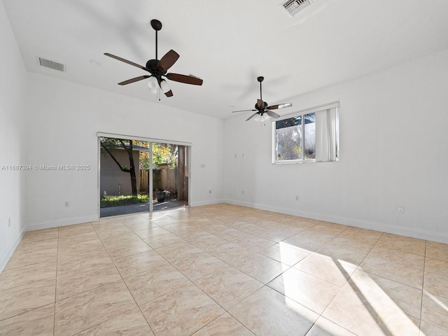 tiled empty room featuring ceiling fan