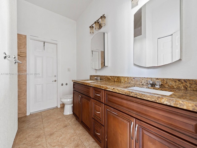 bathroom with tile patterned floors, vanity, and toilet