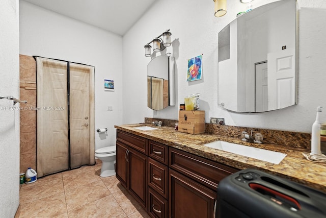 bathroom with vanity, tile patterned floors, and toilet