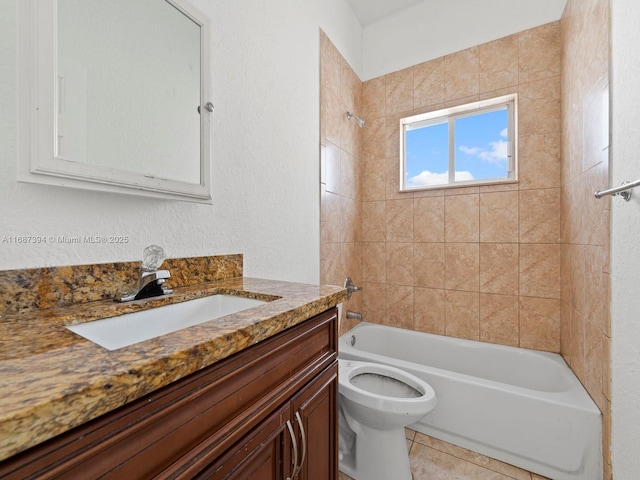 full bathroom featuring tiled shower / bath, vanity, toilet, and tile patterned floors