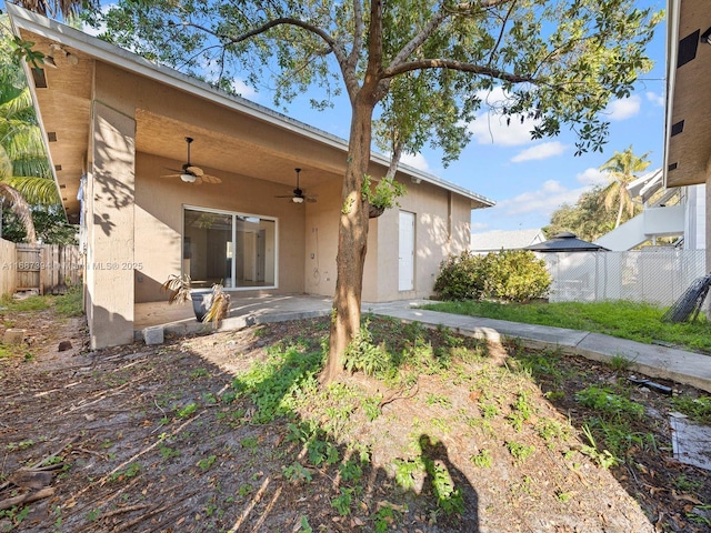 back of property with a patio area and ceiling fan