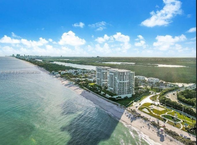 bird's eye view featuring a water view and a beach view