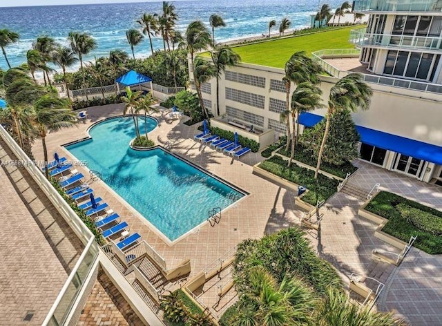 view of swimming pool featuring a patio area and a water view