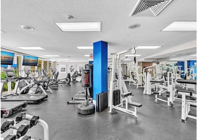 gym featuring a textured ceiling