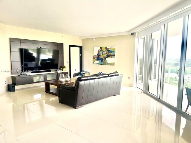 tiled living room featuring floor to ceiling windows