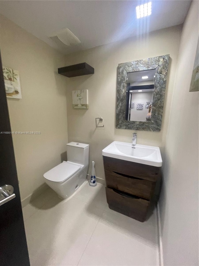 bathroom with vanity, toilet, and tile patterned flooring