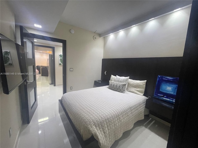 bedroom featuring stainless steel refrigerator