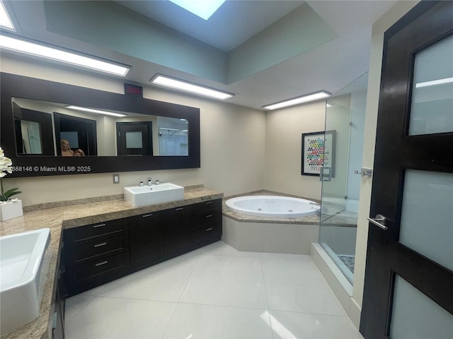 bathroom featuring shower with separate bathtub, vanity, and tile patterned floors