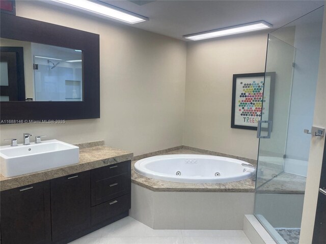 bathroom featuring tile patterned floors, vanity, and shower with separate bathtub