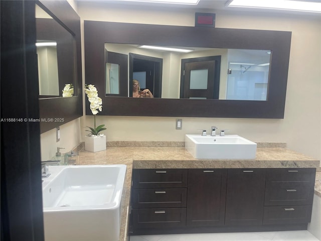 bathroom with walk in shower and vanity