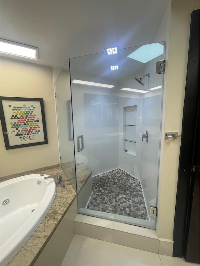 bathroom featuring separate shower and tub and tile patterned flooring