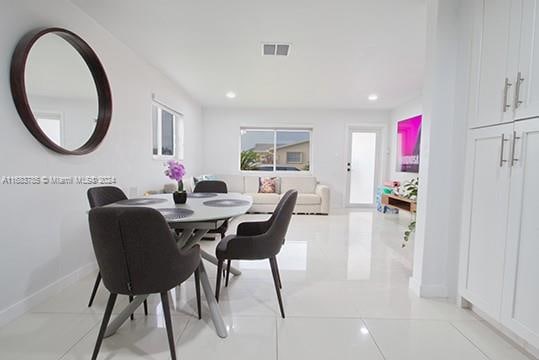 dining area with light tile patterned floors