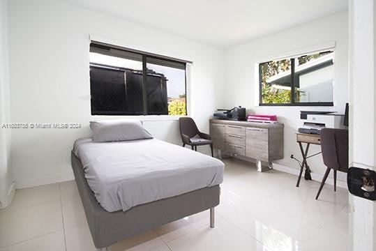 bedroom featuring light tile patterned flooring