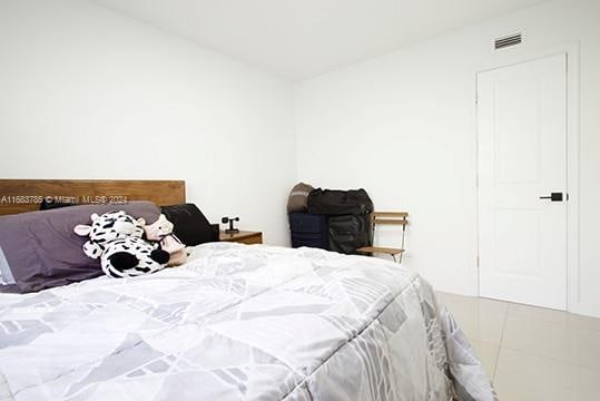 tiled bedroom with vaulted ceiling