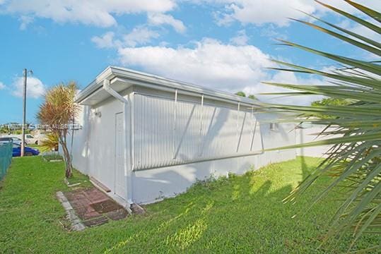 view of side of property with a lawn