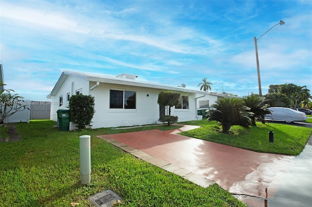 single story home with a patio and a front lawn