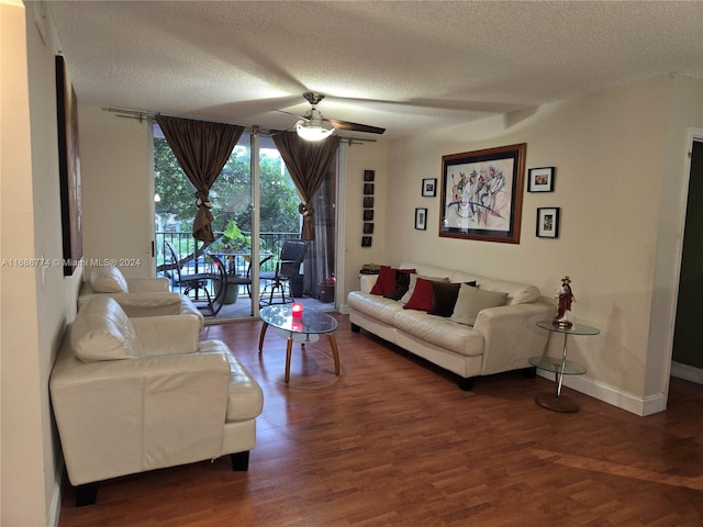 living room with ceiling fan, a textured ceiling, and dark hardwood / wood-style floors