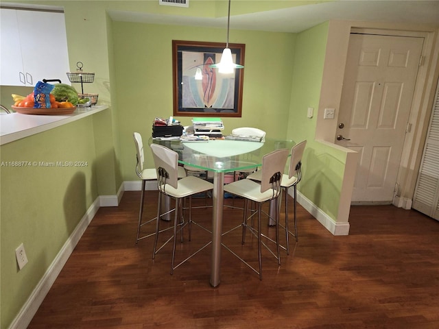 dining area with dark wood-type flooring