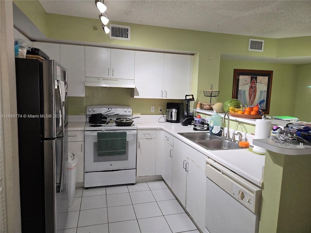 kitchen with white cabinets, white appliances, a textured ceiling, and sink