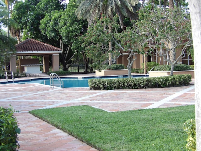 view of swimming pool featuring a lawn and a gazebo