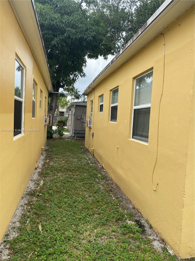 view of home's exterior with a lawn and cooling unit