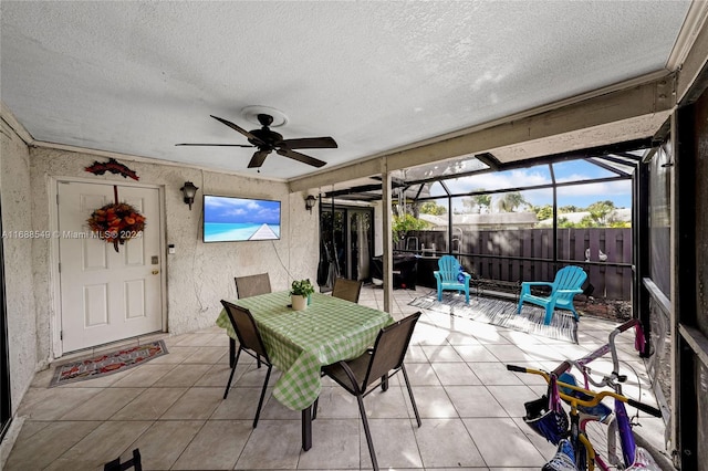 sunroom / solarium featuring ceiling fan